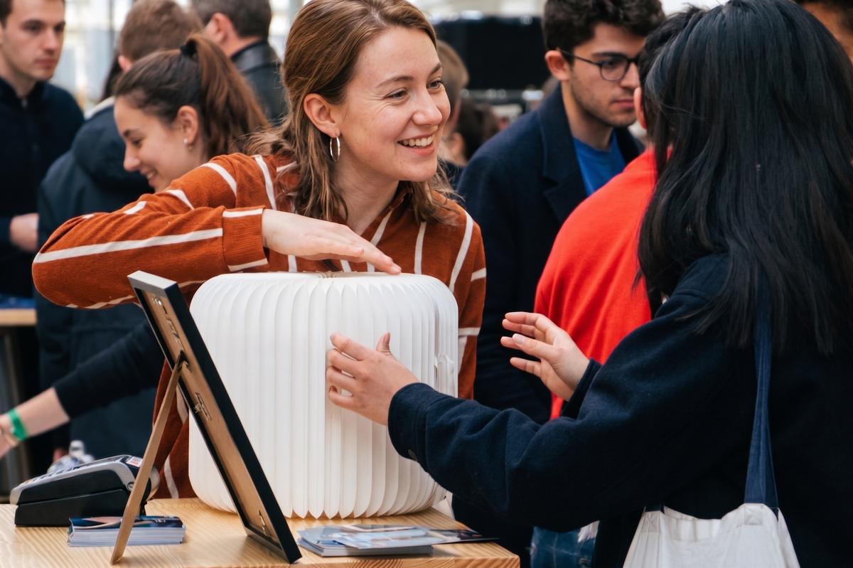 Visiteurs découvrant un meuble Stooly plié sur un stand